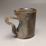 Slab-built soda fired mug with darting (shino cream glaze)