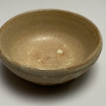 Small flat tan bowl